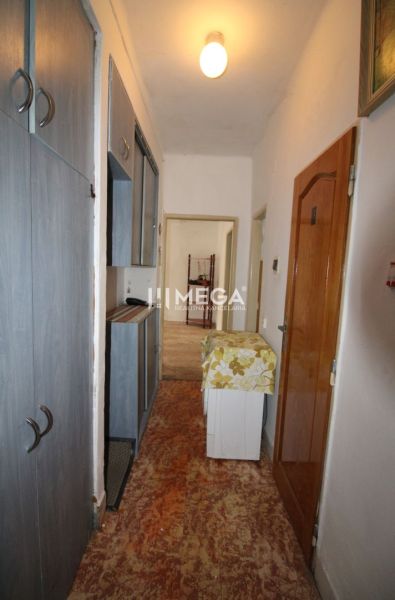 A hallway in a 2-room apartment with storage spaces, carpeted floor.