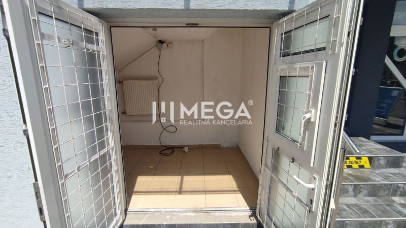 Commercial premises with open doors, tiles, and a radiator.