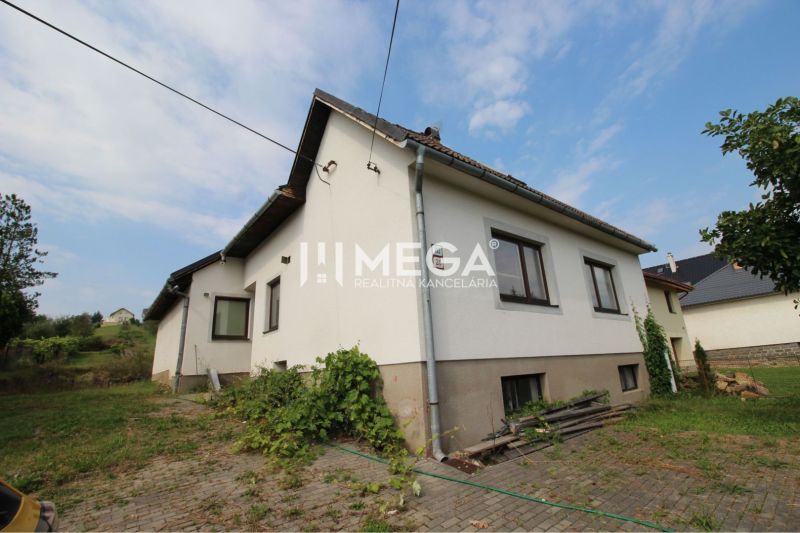 A family house on Brestovska Street in Humenne surrounded by greenery and a paved courtyard.