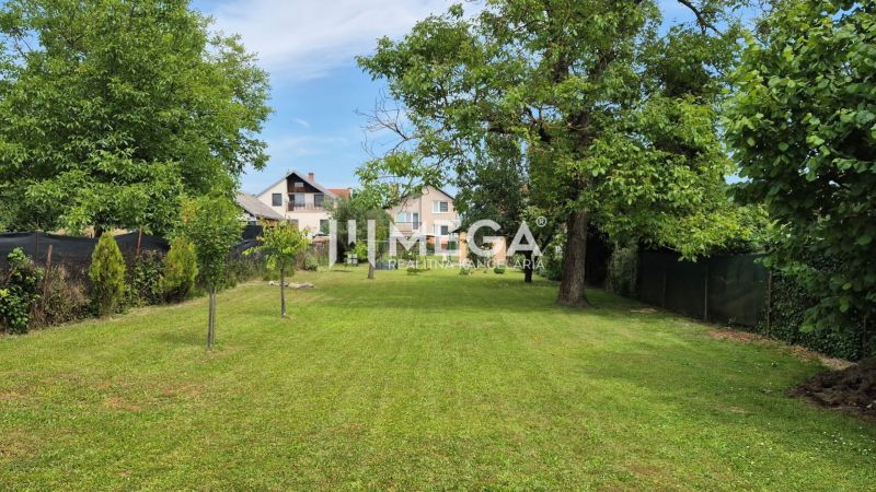 A garden at a family house in Lackovce with a well-maintained lawn and trees.
