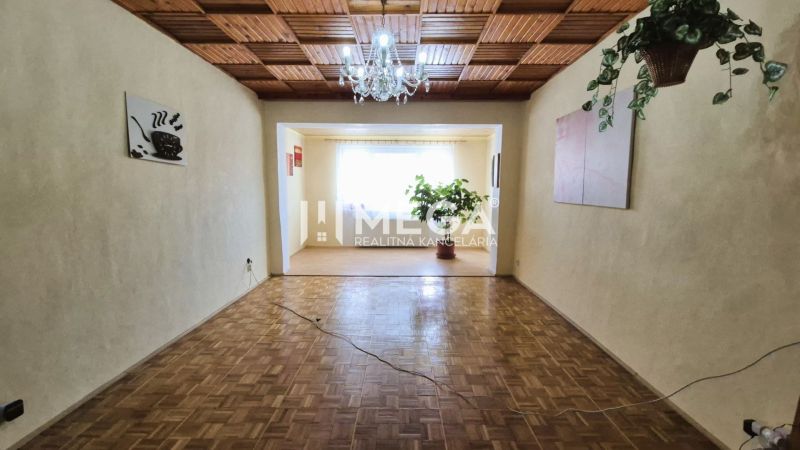 Living room in a family house with a wooden decor floor and a chandelier.