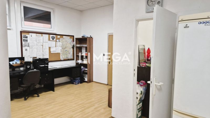 Offices with a desk and decorative flooring appear practically furnished.