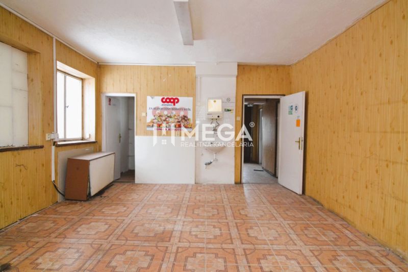 Interior of commercial spaces with wood-patterned flooring and wooden walls.