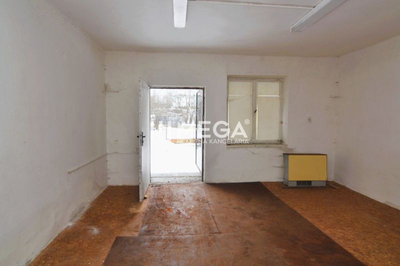 Interior of commercial spaces with wood-patterned flooring and white walls.