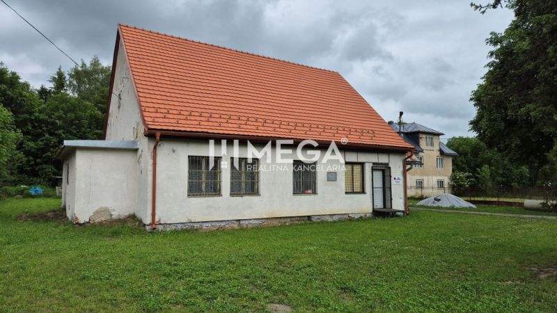 Building in Zboj with a red roof and grassy surroundings. Commercial spaces available.
