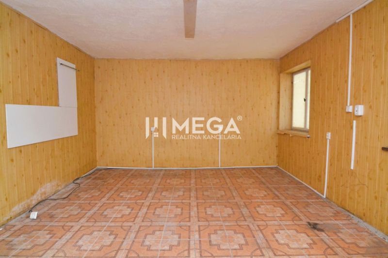 Commercial space with wooden wall decor and a window provides a bright interior.