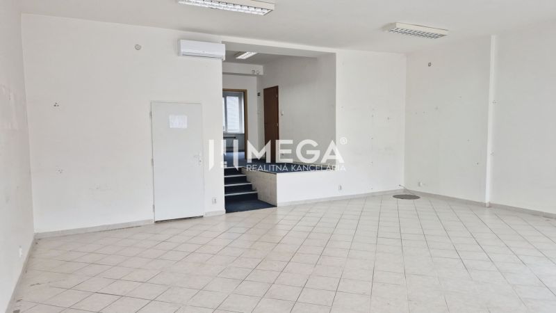 Empty commercial spaces with white walls and ceramic tiles on the floor.