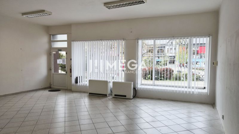 Interior of commercial premises with large windows and tiled floor.