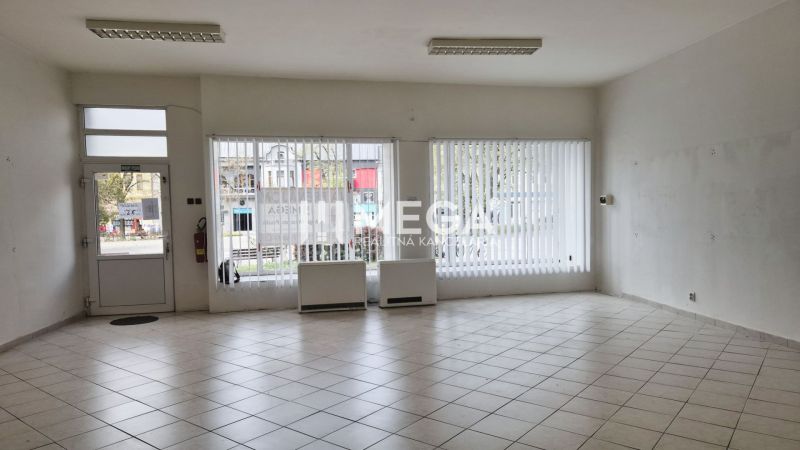 Spacious commercial spaces with large windows and tiled floors.