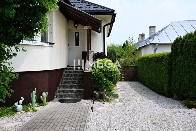 Entrance to a family house in Udavské with a stone walkway and a landscaped garden.