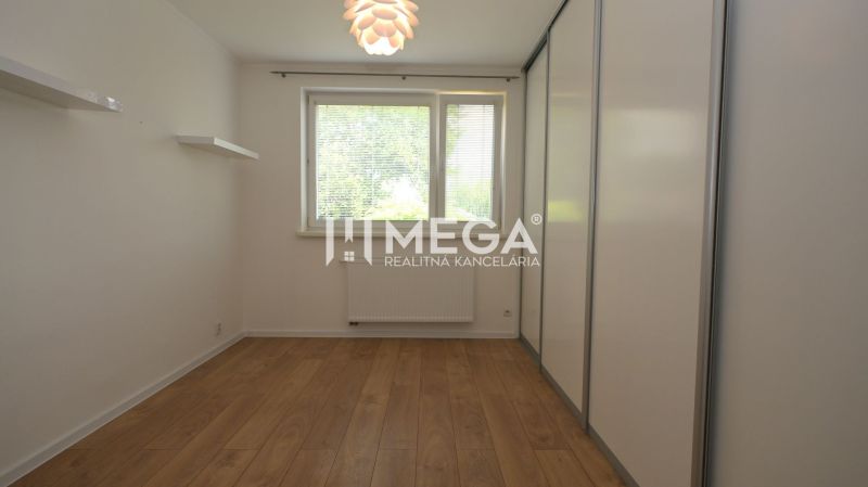 A room with a wooden decor floor and a built-in wardrobe in a family house.