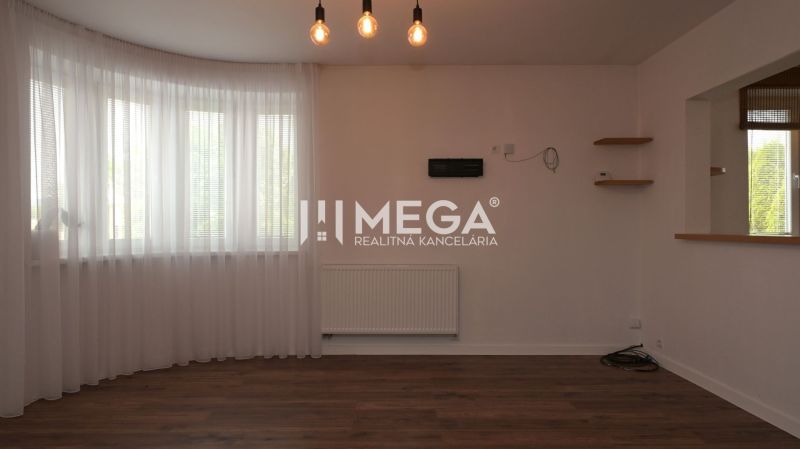 Interior of a family house with a wooden decor floor, curtains, and pendant lights.