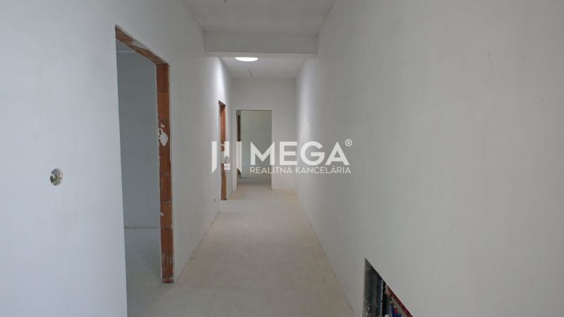 A hallway in a family house with unfinished doors and an unplastered wall.