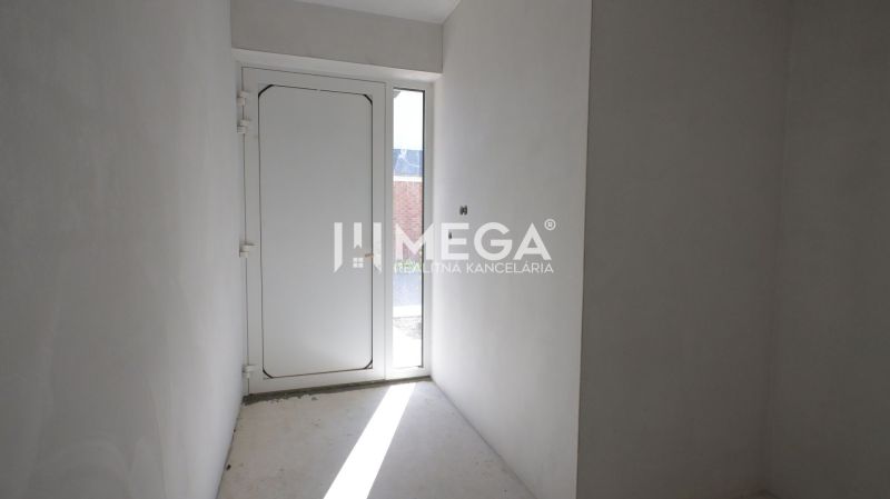A hallway with white walls and doors in a family house.