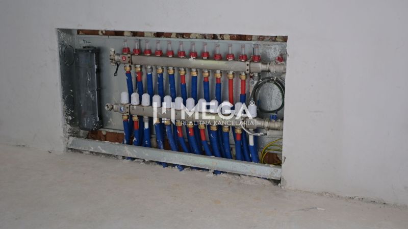 Distribution cabinet of installations in the interior of a family house with blue and red pipes.