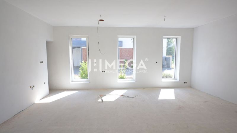 Empty room with large windows in a family house.