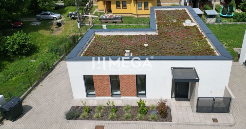 A family house on Gaštanová Street in Humenné with a green roof and a driveway.