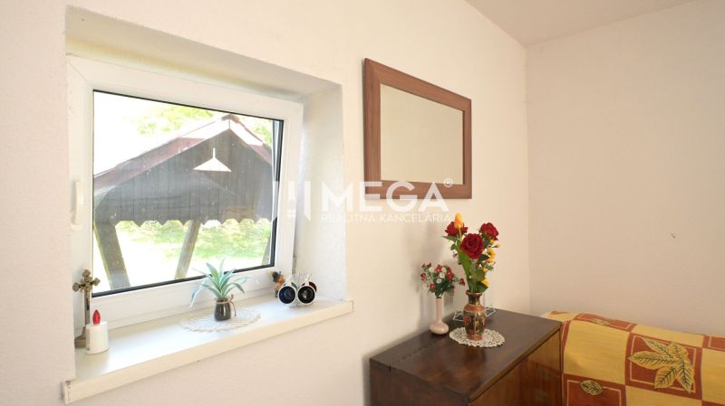 A bouquet and a mirror in a family house, minimalist decor and wooden furniture in the interior.