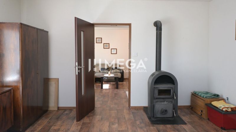 In the family house, there are a stove, cabinets, doors, and a floor with a wooden decor.