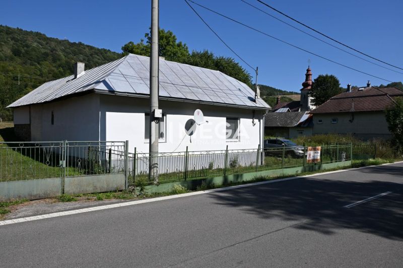 A family house in Kolbasov on Kolbasov Street, with a metal roof and fencing.