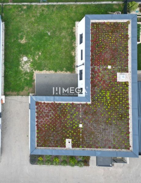 A family house on Gaštanová Street in Humenné with a green roof and an adjacent yard.