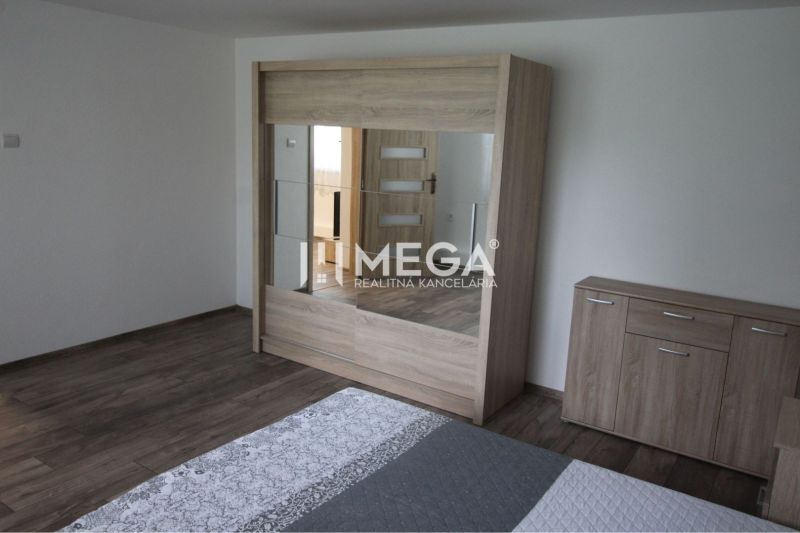 Bedroom with a mirrored wardrobe and a dresser in a family house with a wooden decor floor.