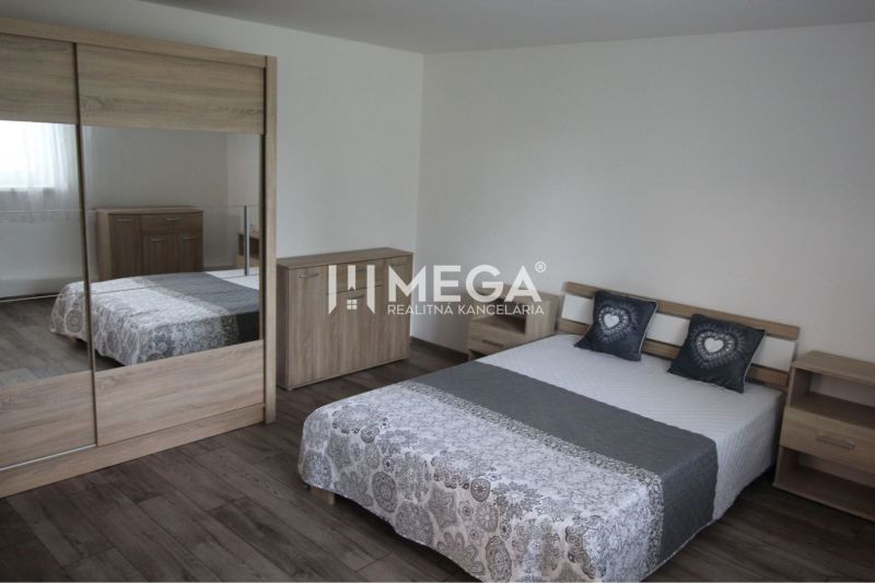 A bedroom in a family house with a wooden decor floor and wooden furniture.