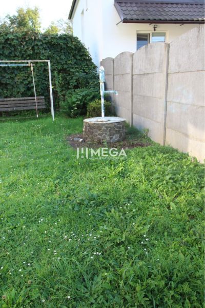 A garden with a lawn and a well at a family house on Staničná Street in Belá nad Cirochou.