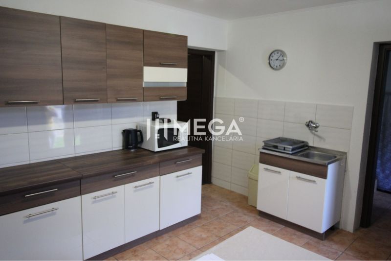 A kitchen in a family house with a wooden decor countertop and tiles.