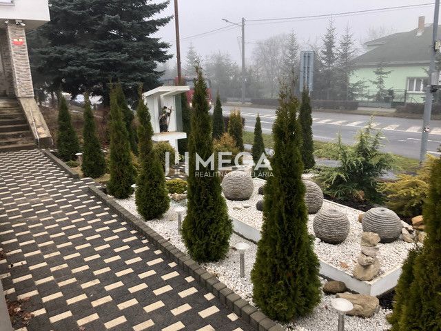 A neatly arranged environment near the building on SNP Street in Snina with decorative stones.