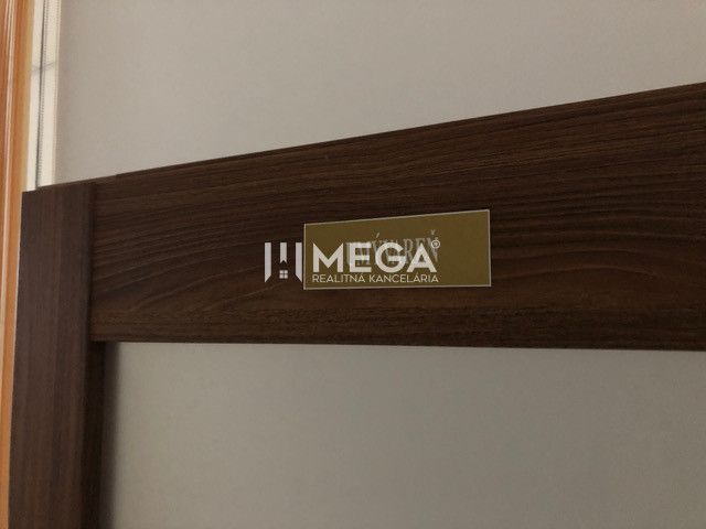 Interior of the building with a detail on the real estate agency's sign and verification certificate.