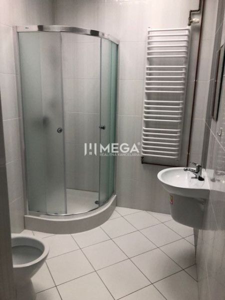 Bathroom with a glass shower enclosure and a sink in the building on SNP in Snina.