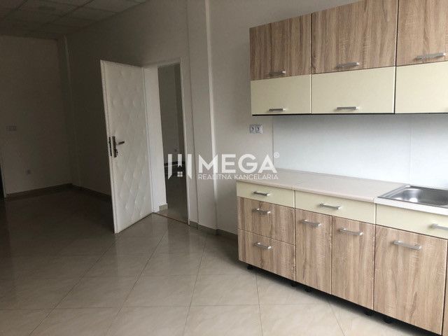 Interior of a building with a kitchen unit and a wooden decor floor.