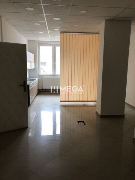 Interior with tiles, kitchen unit, and vertical blinds in the building.