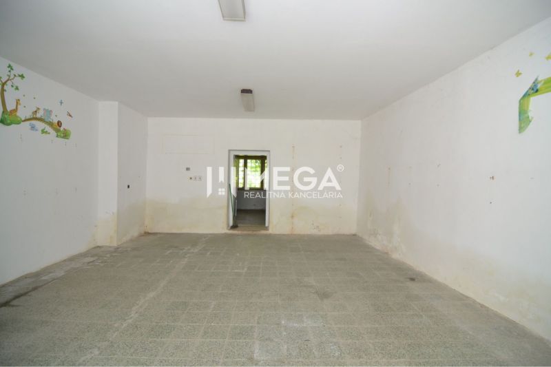 Interior of commercial spaces with white walls and simple flooring, decorated with wall murals.