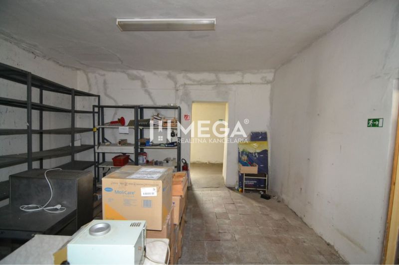 Interior of commercial premises with shelves and cardboard boxes.