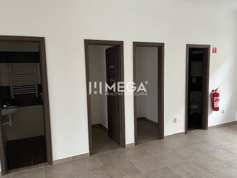 Interior of commercial premises with tiling and multiple doors.
