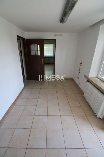 Interior of a 3-room apartment with tiles and wooden doors, illuminated by daylight.