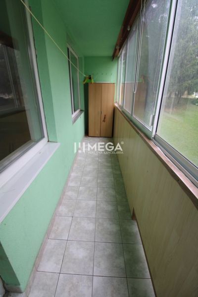 Glazed loggia with tiles and a storage cabinet in a 3-room apartment.