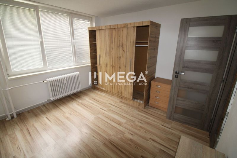 Interior of a 3-room apartment with wooden decor and a large wardrobe.
