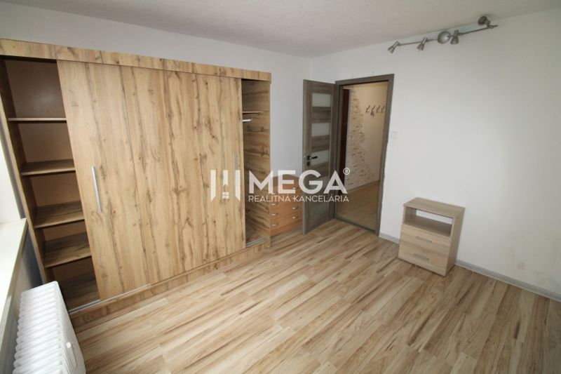 A room with a wooden floor design and a built-in wardrobe in a 3-room apartment.