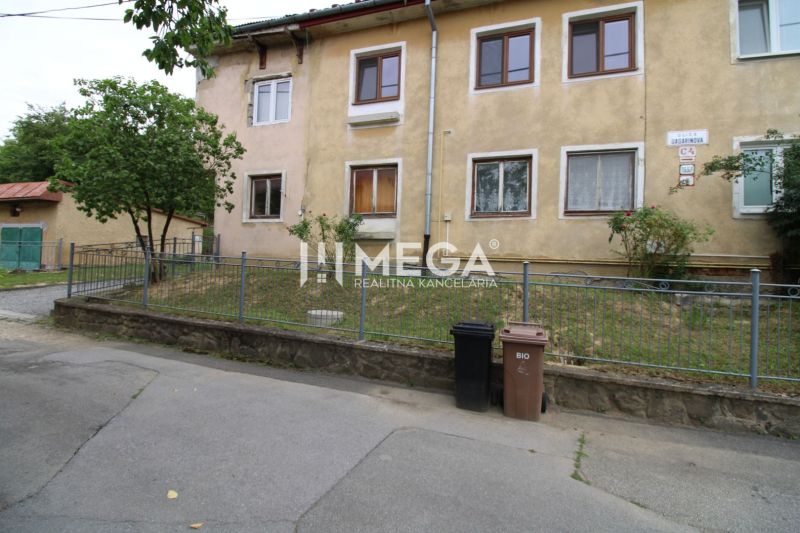 An older 5 or more room apartment on Gagarinova Street in Snina with a small front garden.