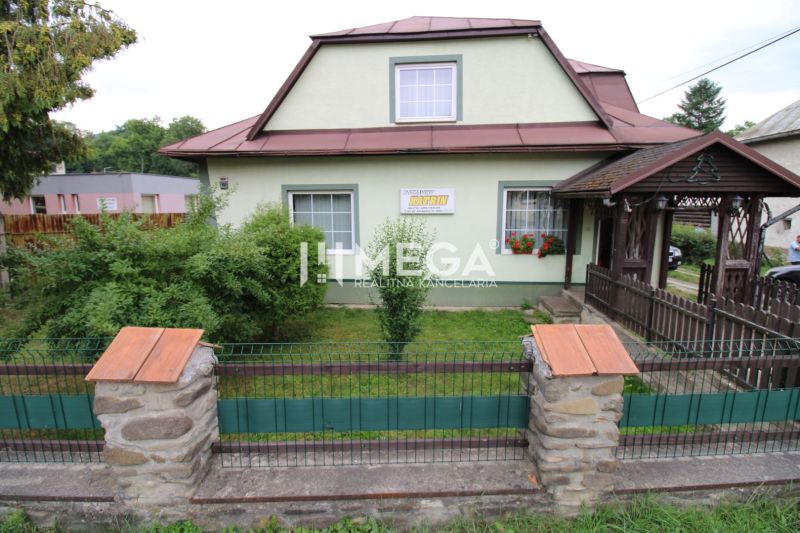 A family house in Ulič at the address Ulič 131 with a front garden and a wooden gate.