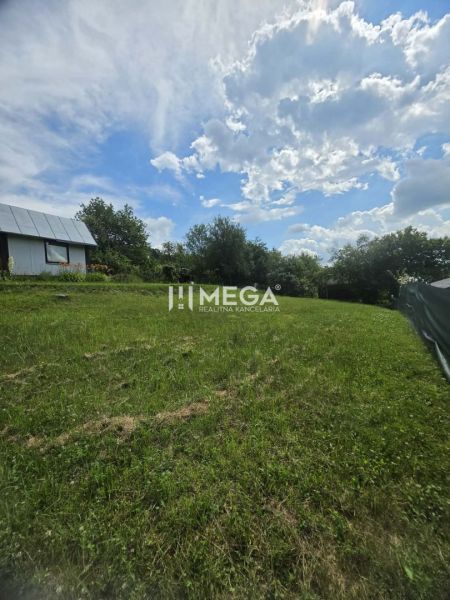 Gardens in Snina on Snina Street with grassy areas and a country cottage.
