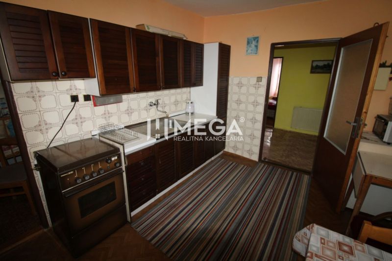 Family house kitchen with kitchen unit, carpet, and wooden decor flooring.