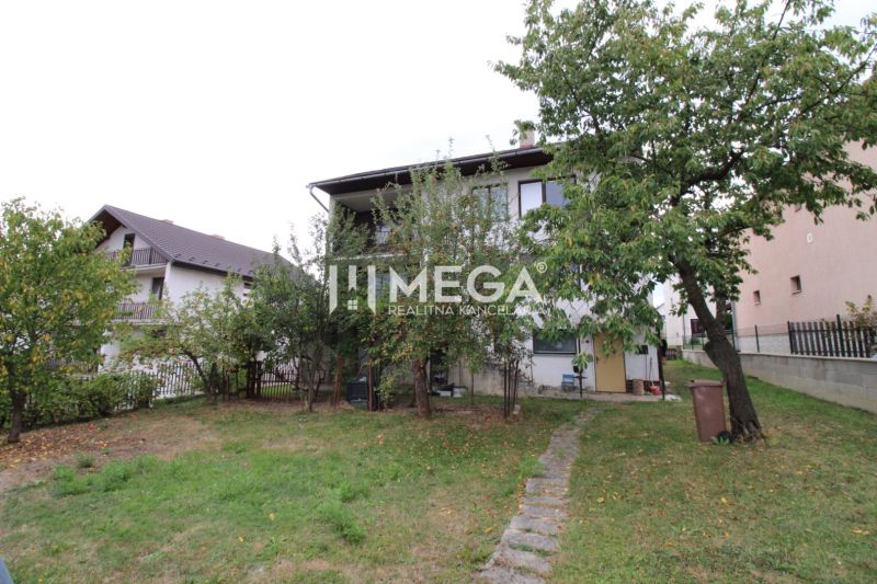 A family house in Snina on Snina Street with a large garden and fruit trees.