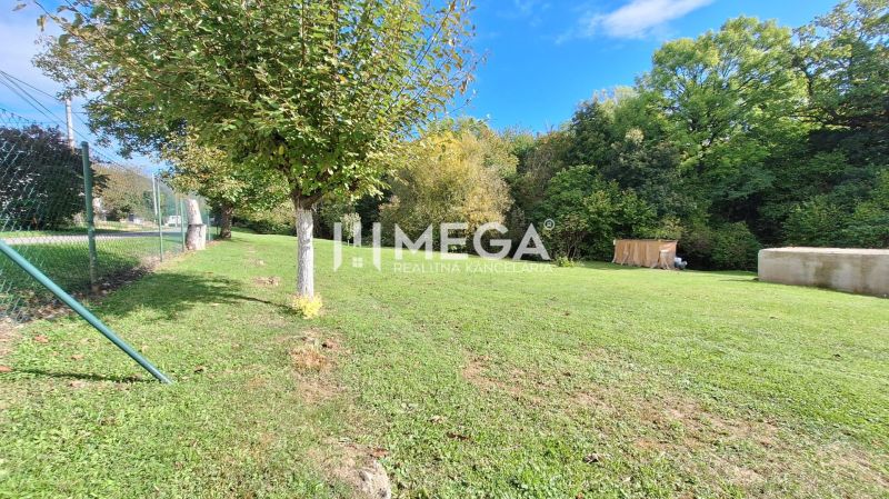 A residential plot in Staré offers a grassy area with fencing and trees.