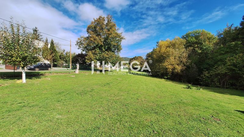 A grassy plot for living in the town of Staré on Staré Street, surrounded by trees.