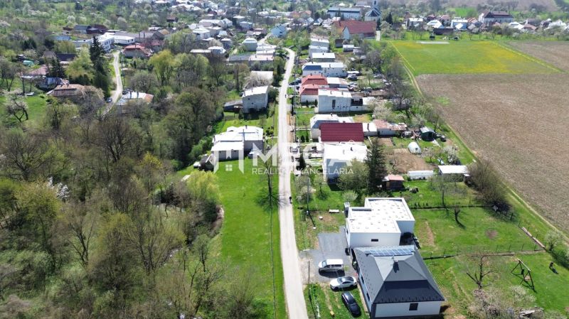 An aerial view of properties - housing with greenery and rural houses in the town of Staré.