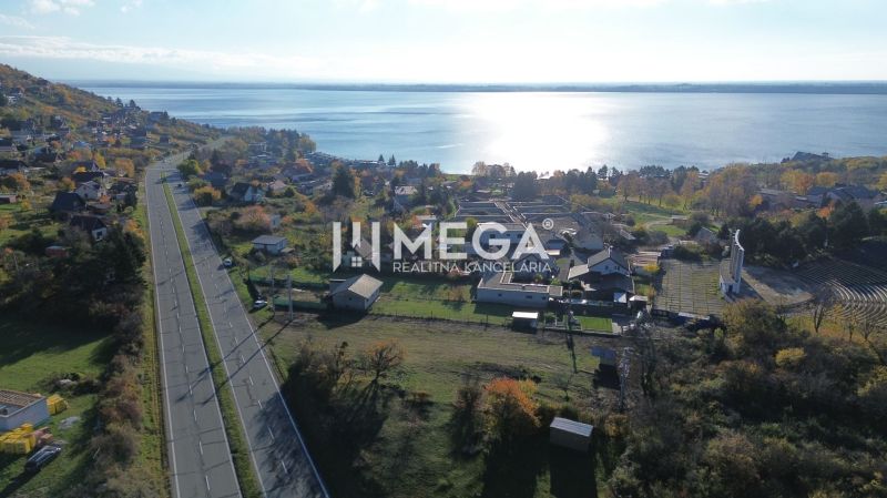 Aerial view of properties in the village of Vinné near the lake in the autumn season.
